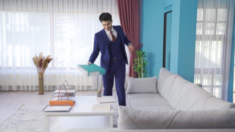 Young-businessman-coming-home-cheerful-and-funny-dancing.